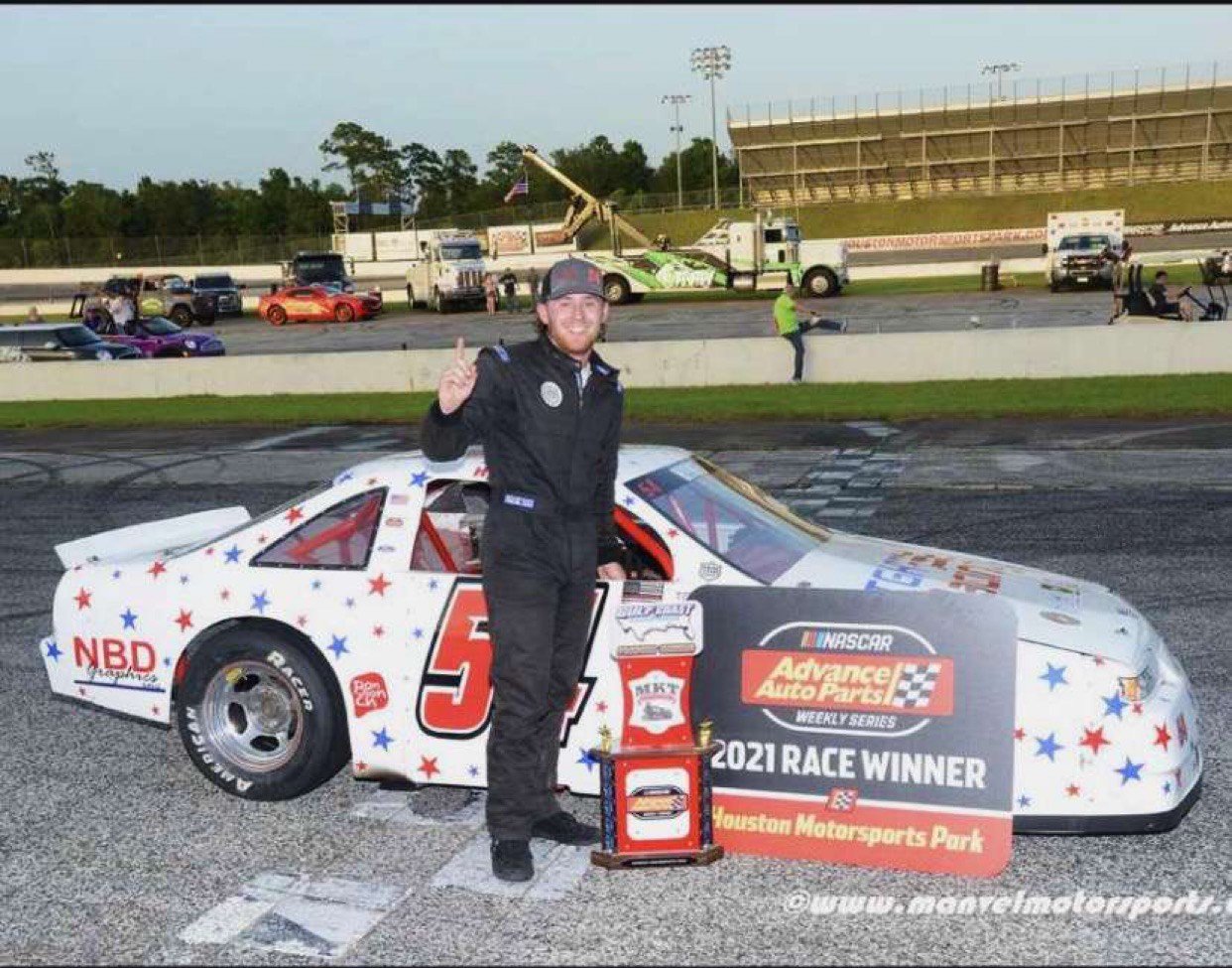 Ty Hymel stands in victory lane at Houston Motorsports Park after winning the NASCAR Advanced Auto Parts Weekly Series race on July 17, 2021.